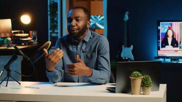 Smiling content creator using professional recording devices to film channel intro for online streaming platforms. BIPOC influencer greets fanbase, presenting today topic photo