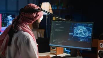 Experienced Arab developer programming scripts on computer screen, employing AI machine learning, manipulating lines of code for artificial intelligence applications computing photo