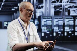 Aged meticulous expert in data center providing dedicated VPN servers able to deliver encrypted sensitive data, increased privacy, online anonymity and secure internet connections to users photo