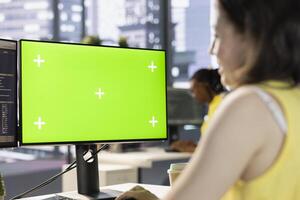 Worker conducting code review on green screen computer to fix bugs, identifying performance and technical issues with artificial intelligence company software. Woman optimizing code mockup PC photo