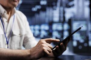 Senior technician in cloud computing business providing dedicated VPN servers able to deliver enhanced privacy, encrypted sensitive data, online anonymity and fast speed bandwidth to users photo