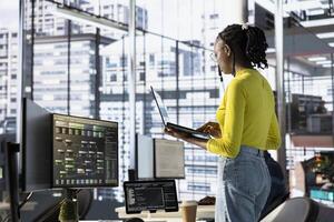 Engineer using laptop device, working with machine learning tech advancing AI critical to innovation of autonomous systems. Woman transforming data into predictive models using notebook photo