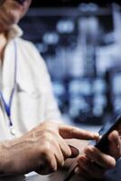 Computer scientist using tablet in high tech workspace, installing dedicated VPN servers able to provide encrypted sensitive data, online anonymity and fast speed bandwidth to clients, close up photo