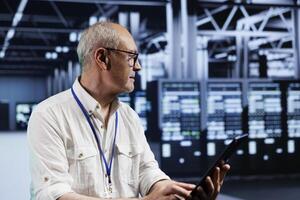 Senior precise manager in data center providing dedicated VPN servers able to deliver encrypted sensitive data, boosted privacy, online anonymity and secure internet connections to users photo