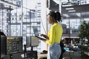 Machine learning infrastructure technician using laptop to develop algorithms that enable machines to learn from data. Admin in office training large scale deep learning models using notebook photo