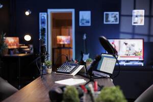 Empty room used for recording podcasts and online discussions, equipped with microphone and sound production. In living room with tv is a makeshift home studio for broadcasting live talk shows. photo