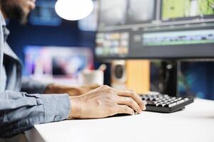 African american freelancer working on movie montage project, creating new white balance and contrast curves before adding visual effects. editor colorist adjusting footage clips. photo