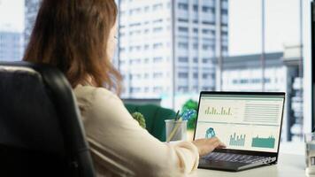 Female entrepreneur working on financial planning and budget allocation, ensuring the company resources are used effectively to achieve maximum profit and long term business objectives. Camera B. photo