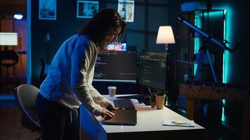 Programmer closing backpack, leaving home office after filtering malicious traffic from cybercriminals. Woman finishing job shift after being done with preventing malware, camera B photo