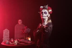 Portrait of woman doing enticing invitation hand gesture for Day of the Dead Mexican celebration. Lady doing seducing wooing gesturing during ancient Aztec custom of celebrating ancestors photo