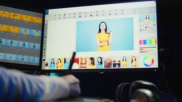 Photo editor using graphic tablet to retouch photographs with editing software on, zooming in to find spots that need correcting. Photographer in creative workplace adjusting images, camera B