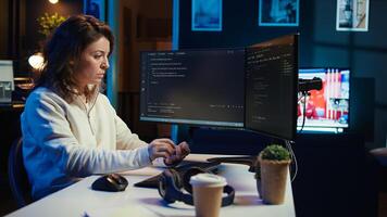 Teleworking system administrator futureproofing company network from downtimes and unexpected failures. Remote IT employee typing on keyboard, increasing data security, camera B photo
