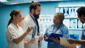 Doctors and radiologists review human anatomy scans to develop treatment service. Doing teamwork and expertise in radiology and diagnostics for correct healthcare solutions. Camera A. photo