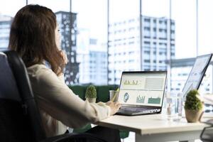 Ambitious woman executive ensuring corporate innovation, exploring new technologies and business models to enhance the company competitive advantage. Evaluating results and analytics. photo