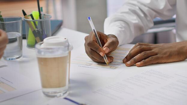 Job candidate with disability filling in the application form for the interview, registering resume within multinational company database with diversity and inclusion policy. Close up. Camera A. photo