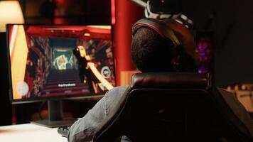 Pro gamer in studio teaching subscribers strategies to beat foes during livestream. Man streaming live from RGB lit living room, recording videogames esports guide for internet audience photo