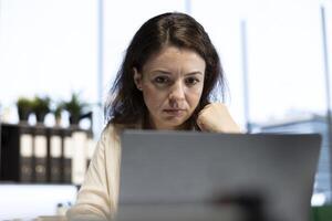 Confident female leader driven by empowerment and ambition, focuses on achieving business targets and enhancing company performance in a dynamic office setting. Leadership success story. photo