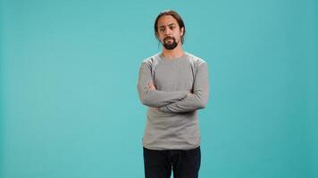 Grumpy man crossing arms, feeling upset by events, isolated over studio background. Portrait of stressed moody person shaking head, left speechless by troubling news, camera A photo
