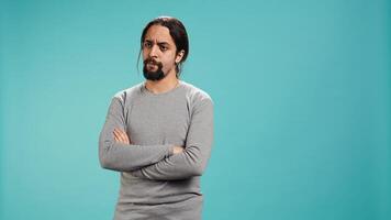 Man shakes head, showing negative emotion, showing lack of satisfaction, isolated over studio background. Irked person disagreeing with friend during conversation, studio backdrop, camera B photo
