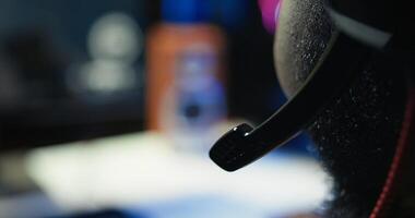 Man having fun playing videogames on PC while chatting with teammates through headphones mic. Close up of gamer battling rival players, communicating with friends through headset microphone, camera B photo