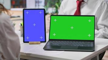 Team of recruiters interviewing job applicant with a green screen on desk, discussing about potential career development plans and his aspirations. Women attend an interview with candidate. Camera A. photo