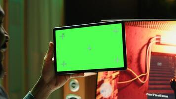 Player watching tutorial guide videos on isolated screen tablet to learn how to win computer videogame. Close up of player looking at mockup device display while enjoying internet multiplayer PC game photo