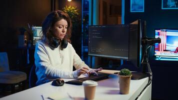 Programmer teleworking from own apartment filtering malicious traffic from cybercriminals attempting to corrupt company data using computer, preventing phishing attacks, camera B panning shot photo