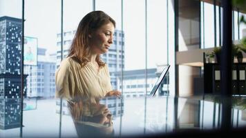 Determined female entrepreneur oversees a strategic review of the company activity, analyzing market trends and setting new priorities. Ensuring the enterprise objectives achievements. Camera A. photo