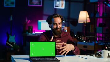 Entertainer presents chroma key laptop from brand sponsoring , analyzing features. Content creator reviewing green screen notebook for technology enthusiasts, inspecting materials, camera A photo