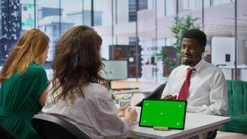 Recruiters and job applicant attending an interview with isolated copy space device, HR staff asking candidate about career achievements and goals. Reading qualifications on the resume. Camera B. photo