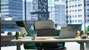 Empty modern corporate high end office space designed for a CEO or person with authority, running analytics and reports on screen. Urban global enterprise workspace, empowerment. photo