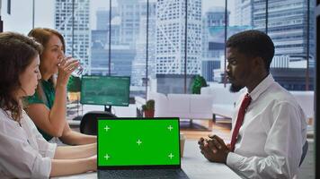 Interviewers meeting with a job candidate about a vacancy next to green screen, HR team attending interview with applicant during recruitment process. Headhunting concept. Camera B. photo