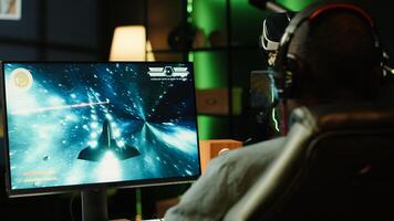Man wearing headphones playing game, teaching subscribers professional esport skills, close up shot. Media star using headset mic to chat with viewers, filming gaming tutorial, camera A photo