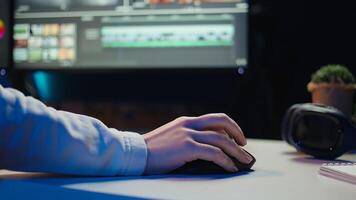 Extreme close up shot of editor selecting key frames to use while doing montage, working from home on computer. Woman using mouse to edit movie project footage in studio, camera B photo