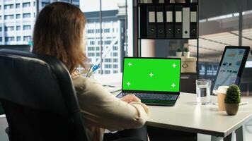Woman chief executive officer working with mockup copy space screen on device, developing a project for enterprise growth and objectives achievement. Female director with determination. Camera A. photo