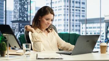 Female CEO solving her business paperwork tasks and signing documents, approving requests from employees and authorizing work contracts in her high end office. Legal management. Camera A. photo