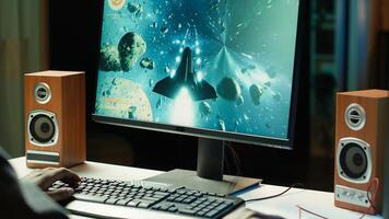 Man at home using high end computer system to play demanding science fiction videogame. Gamer enjoying high quality game, streaming it online, shooting laser beams with spaceship, camera A photo