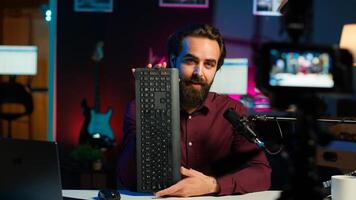 Influencer endorsing wireless mouse and keyboard from sponsor, showing functionalities. Internet star promotes computer peripherals from partnering brand to followers on social media, camera A photo