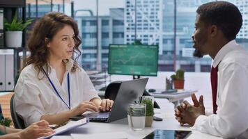 Job candidate sits across from interviewers team in high end office, presenting qualifications and discussing various job opportunities or career paths within the company. Employment. Camera A. photo