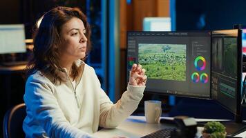 editor working for production company checking stills on camera gallery before inputting music, dialogues, graphics and effects over raw footage, editing clips for final project, camera A photo