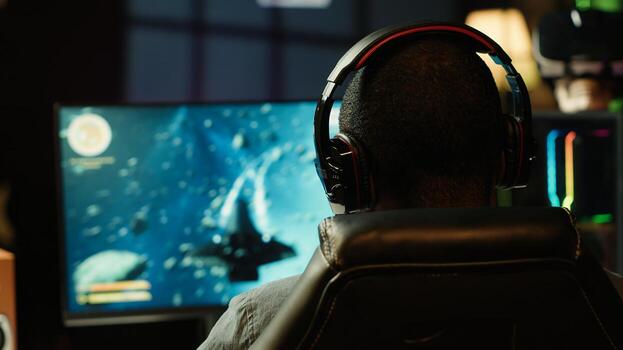 Man at home shooting asteroids in spaceship flying singleplayer game with overlay HUD showing health, fuel, ammo bars and minimap. Gamer navigating universe in simulation game, close up, camera A photo