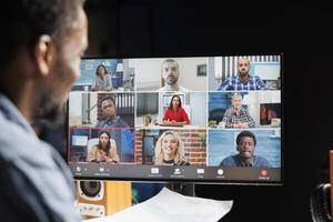 Young manager attending videocall with employees team, discussing about latest company news or changes. People working from home and meeting on online link, teleworking. photo