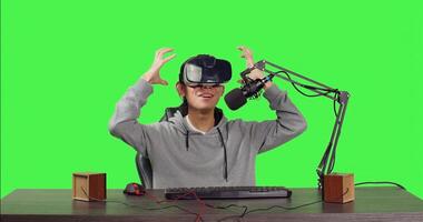 POV of vlogger using virtual reality to stream live gaming battle while sitting at his workstation, playing web challenge. Male streamer recording interactive broadcast using vr headset. photo