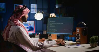 Technician writing script code on computer screen using Java programming languages for outsourced project. Teleworking employee at home fixing intranet database errors, handheld camera shot photo