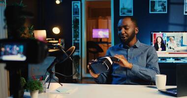 Tech content creator filming sponsored unboxing of newly released gaming VR glasses product. Viral internet star offers virtual reality headset recommendation to subscribers on online platforms photo