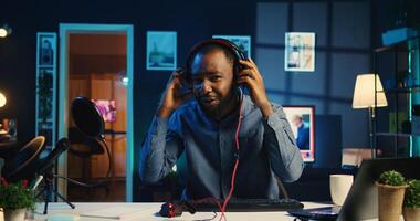 African american technology internet star filming review of newly released wired gaming peripherals, giving audience feedback about them and presenting specifications, doing endorsement photo