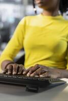 Meticulous accountant imputing revenue figures on computer in office. Adept employee at desk focused on typing company statistical numbers, working hard to finish job before deadline photo