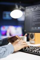 Software analyst applies programming skills to supply server security, using binary algorithms and html code on terminal window. Protection of databases is handled by IT engineer. Close up. photo