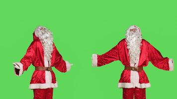 Unsure santa claus acting doubtful, doing i dont know gesture in studio while he wears festive december costume. Saint nick character being uncertain about solution, clueless model. photo