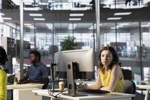 IT employees in office working at computer desks, testing and deploying programs and systems. Programmer and developers checking code on desktop PCs, solving tasks in workspace photo